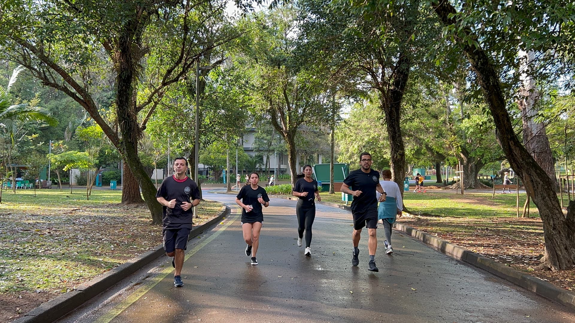 Prof. Nicolas orientando uma aluna em exercício de agachamento no parque